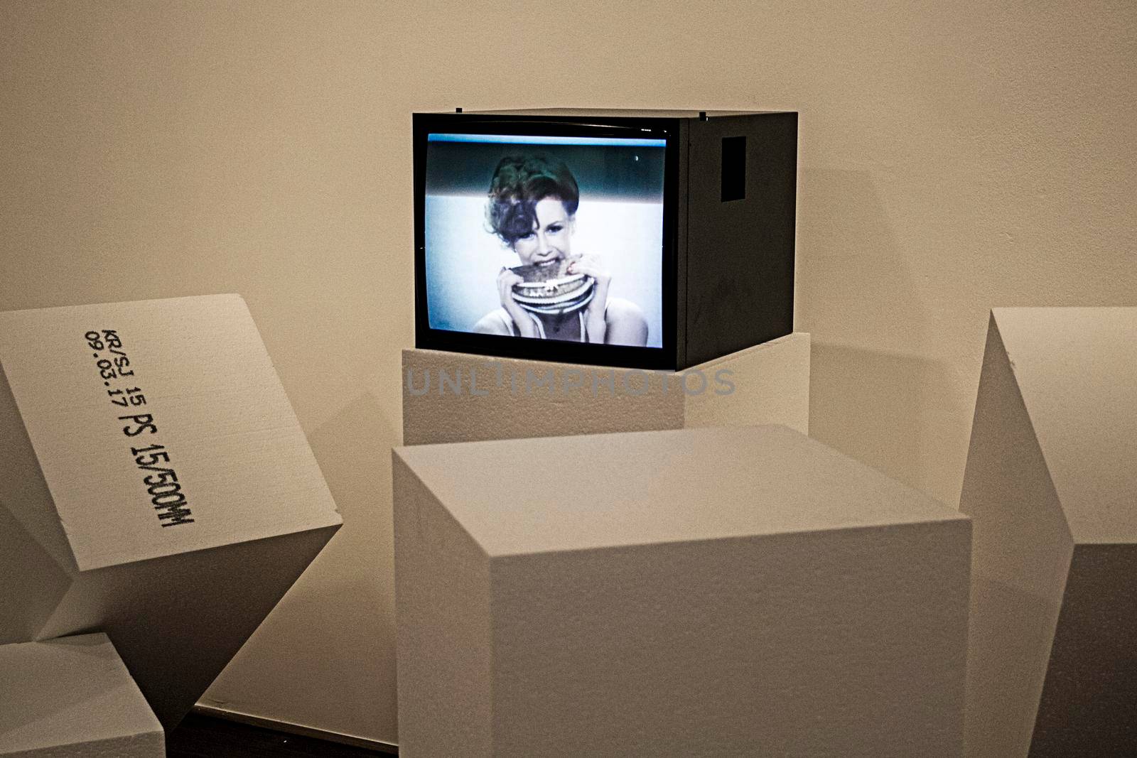 Modern art composition with a television and some cubes in a museum