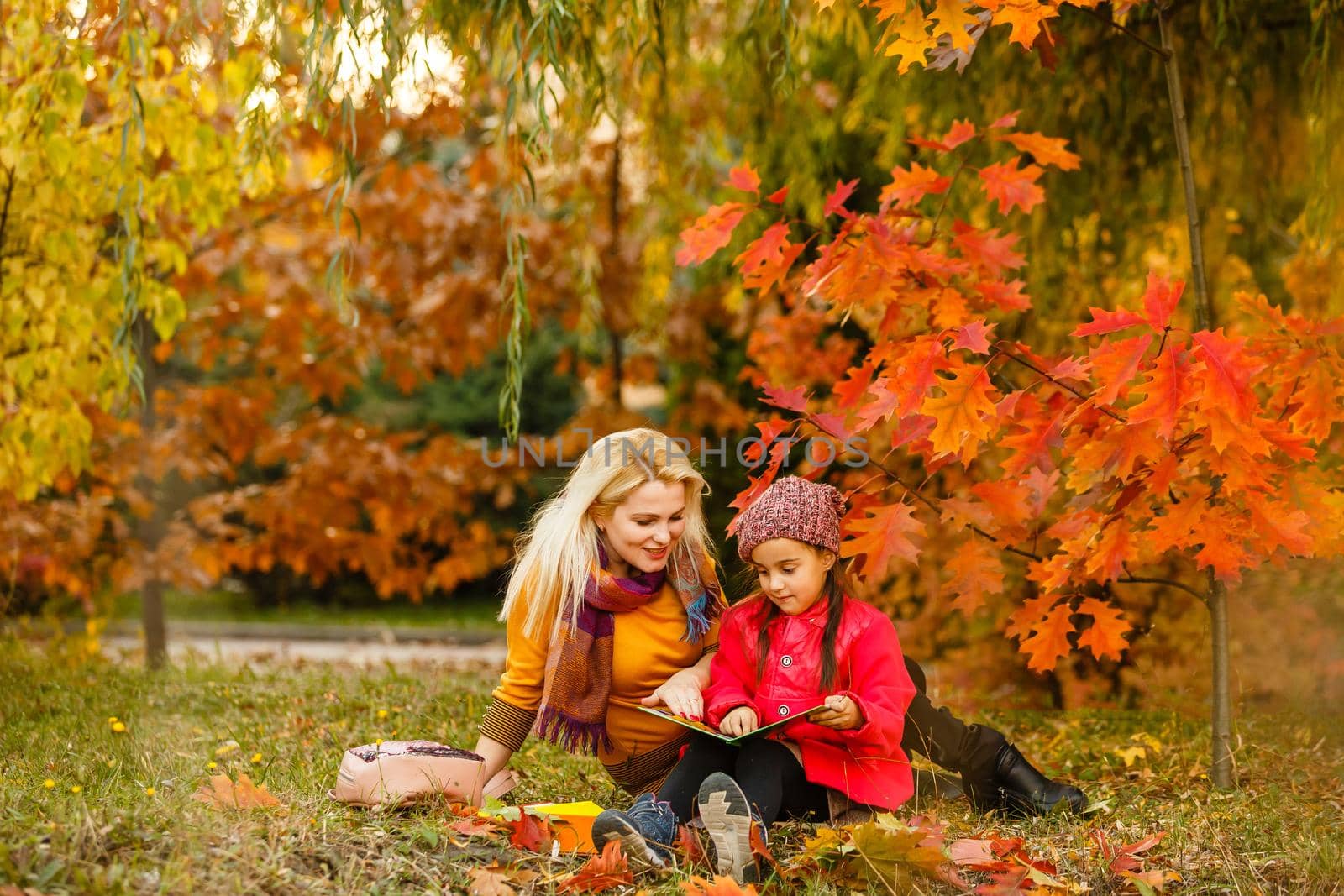 Outdoor fashion photo of young beautiful lady surrounded autumn leaves