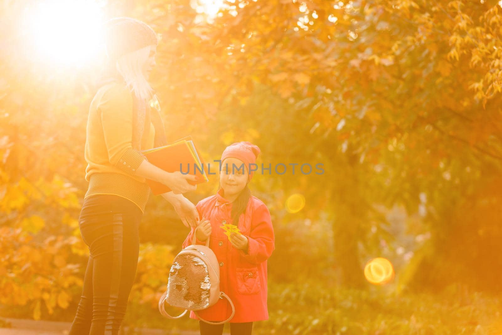 portrait of a young woman and her daughter in the autumn park by Andelov13