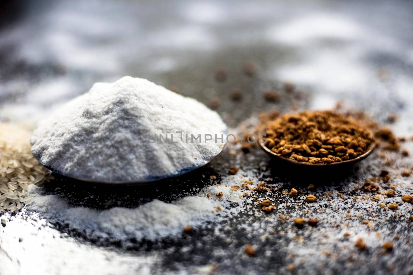 Hair growth remedy of rice flour water and fenugreek seed powder on wooden surface. by mirzamlk