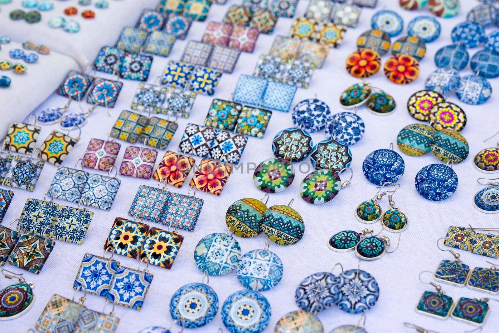Glass square and round earrings with azulejo elements on the market in Porto