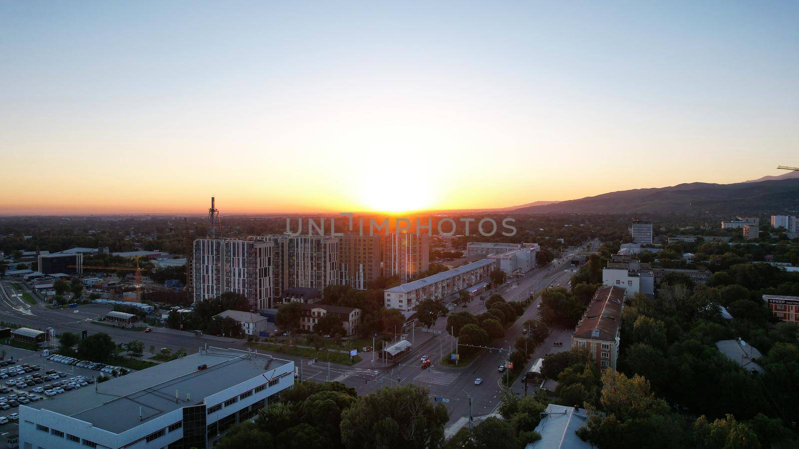 Dawn over tall houses and the city of Almaty by Passcal