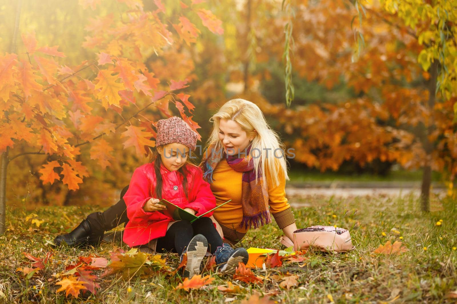 Outdoor fashion photo of young beautiful lady surrounded autumn leaves