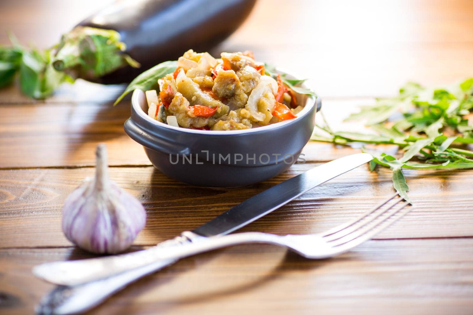 eggplant fried sauteed with other vegetables in a plate on a wooden table