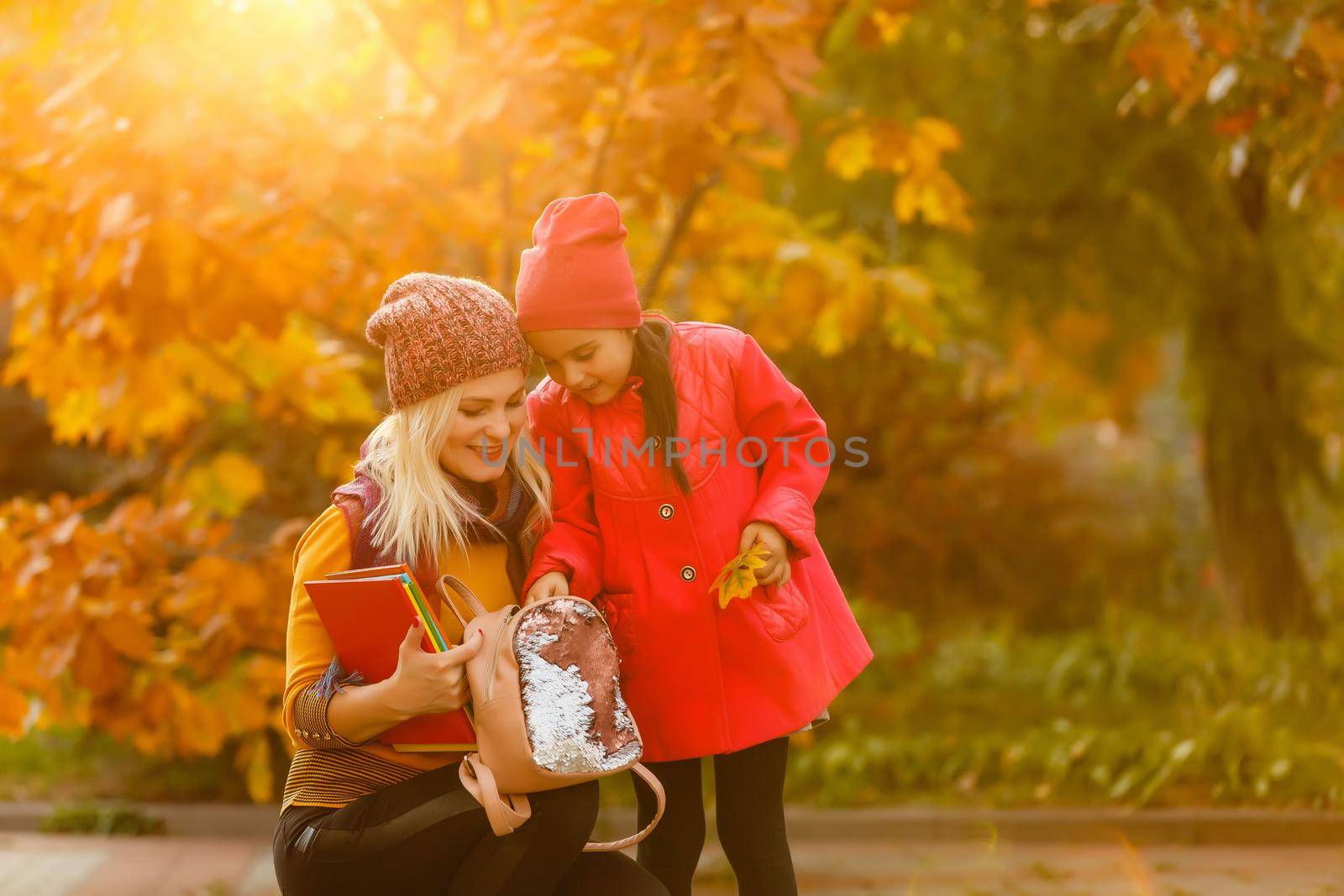 Young beautiful mother escorts her daughter to the first class.