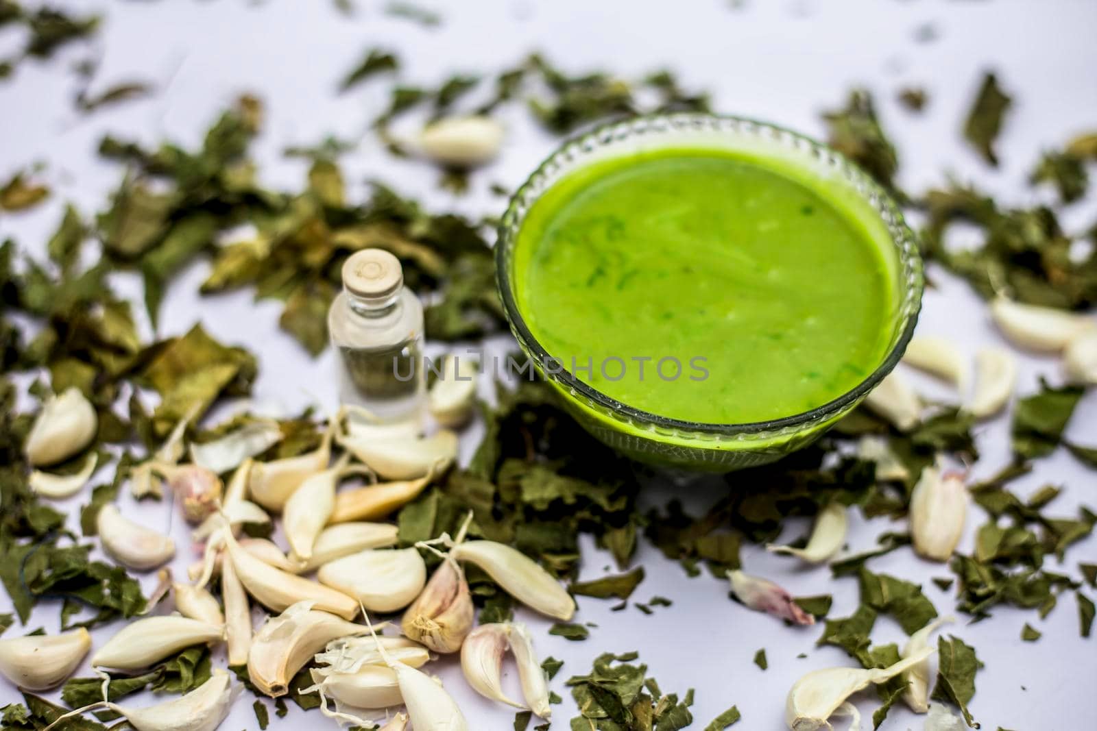 Neem or Indian Lilac face mask isolated on a white surface for skin infection of neem leaves paste, garlic cloves and coconut oil.