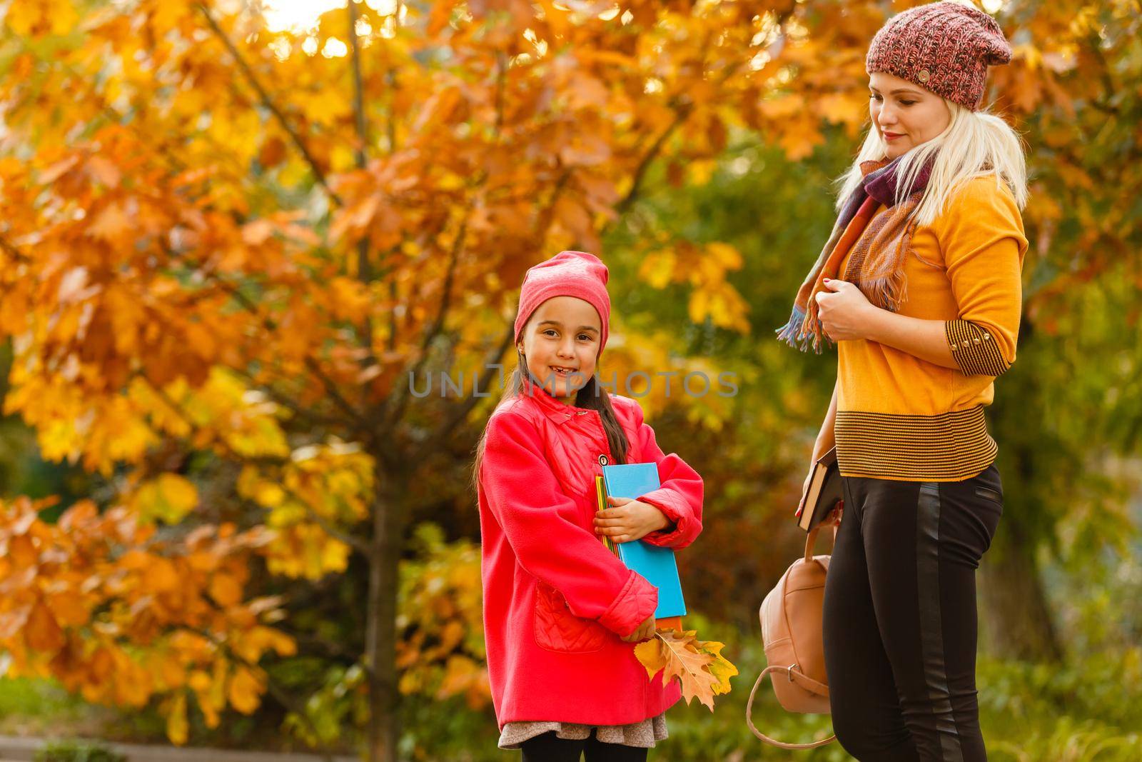 Young beautiful mother escorts her daughter to the first class.