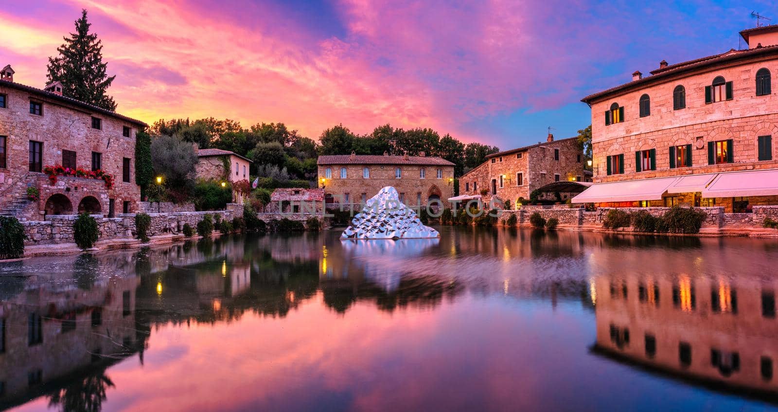 Thermal bath town of Bagno Vignoni, Italy during sunrise. Old thermal baths in the medieval village Bagno Vignoni, Tuscany, Italy. Medieval thermal baths in village Bagno Vignoni, Tuscany, Italy 