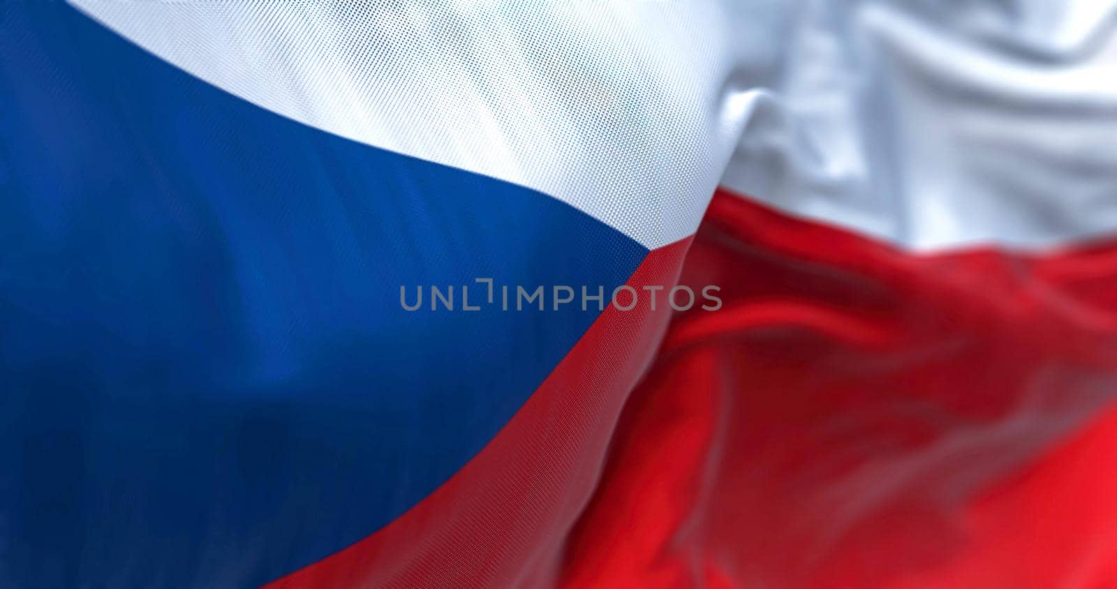 Close-up view of the Czech Republic national flag waving in the wind. Czech republic is a landlocked country in Central Europe. Fabric textured background. Selective focus