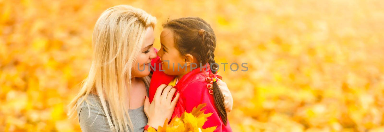 happy family mother with her daughter playing and laughing on autumn walk
