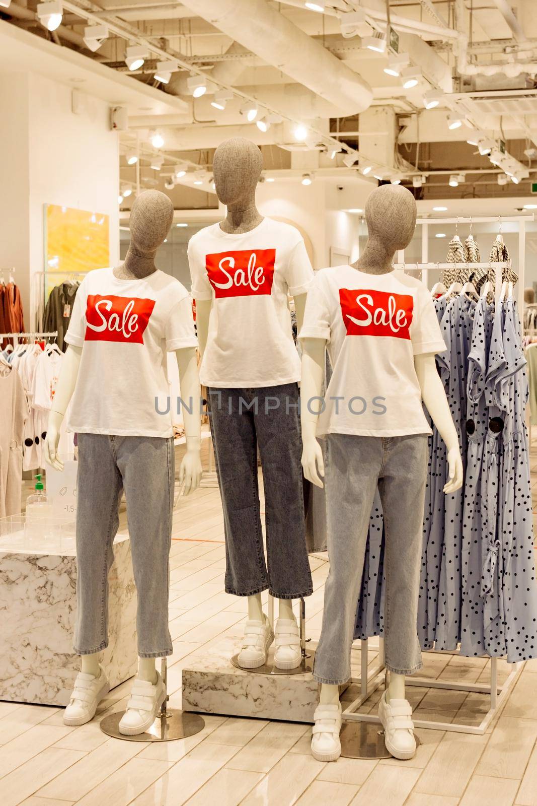 Faceless mannequins in casual clothes in fashion shop clothing store, black friday sale shopping concept, seasonal offer promo, vertical image, selective focus