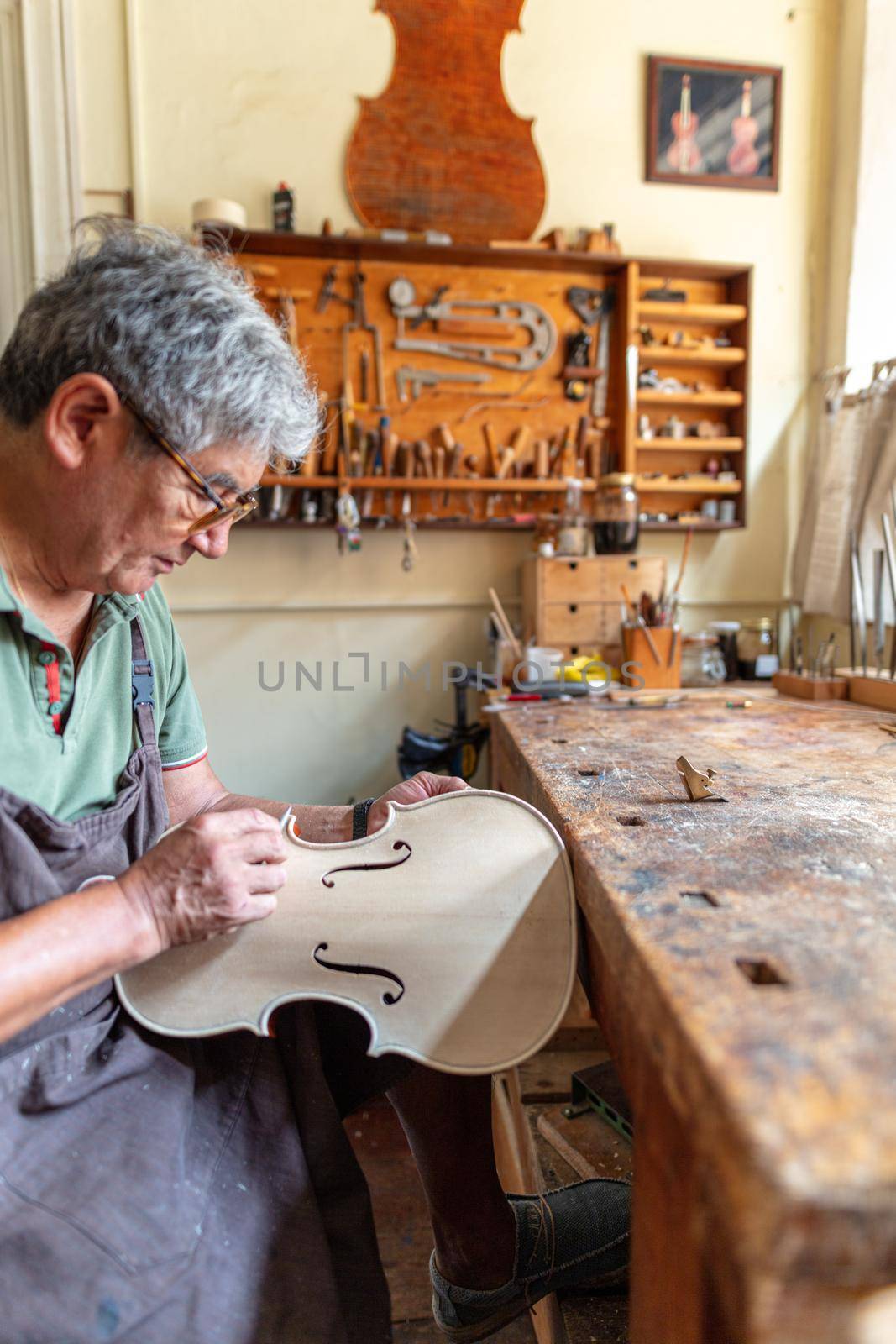 violinmaker at work in his italian workshop
