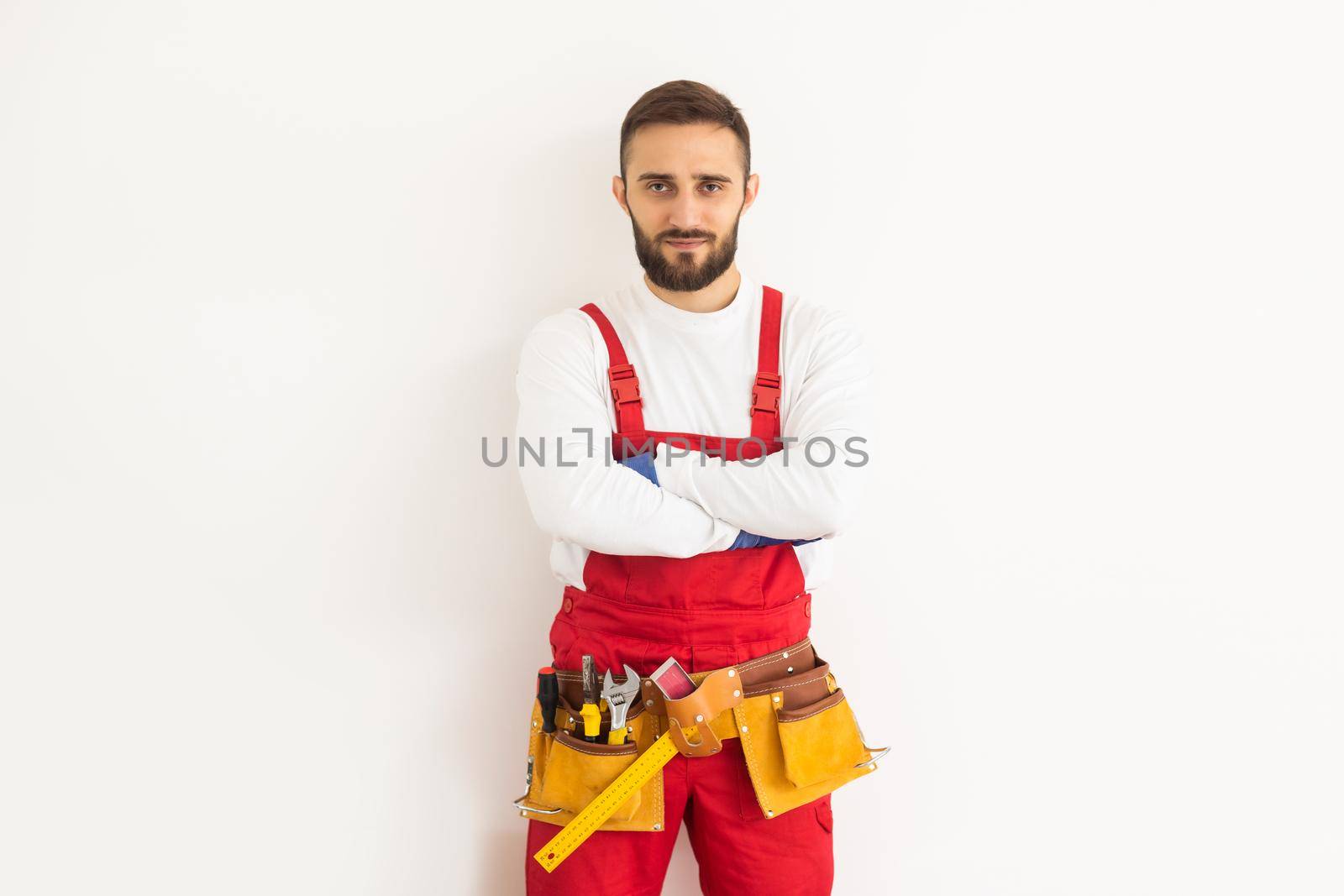 Man builder in a robe, overalls on a white background. Isolate, copy space.