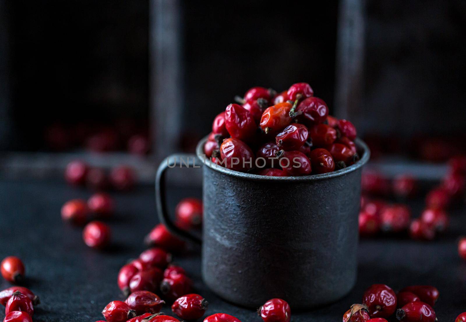 Rosehip in the cup. Benefits and used as a natural remedy. Natural therapy. dark mode style.