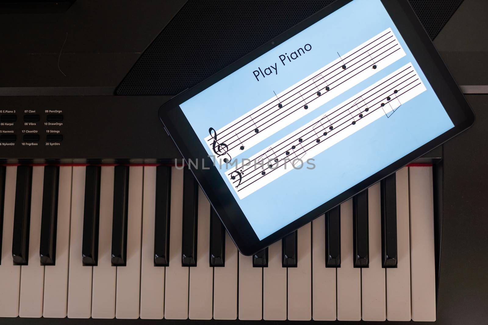 Piano synthesizer app on tablet and musical instrument concept by Andelov13