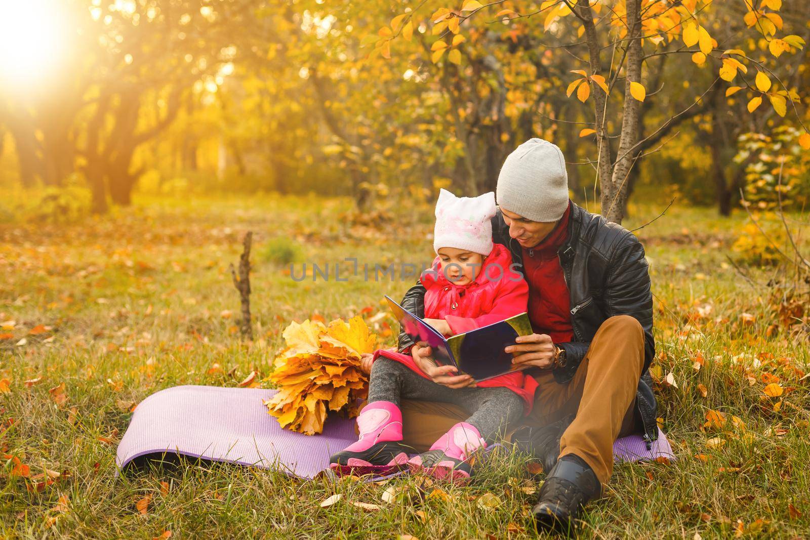 Happy family. daughter kissing and hugging her dad on a walk in the autumn leaf fall in park