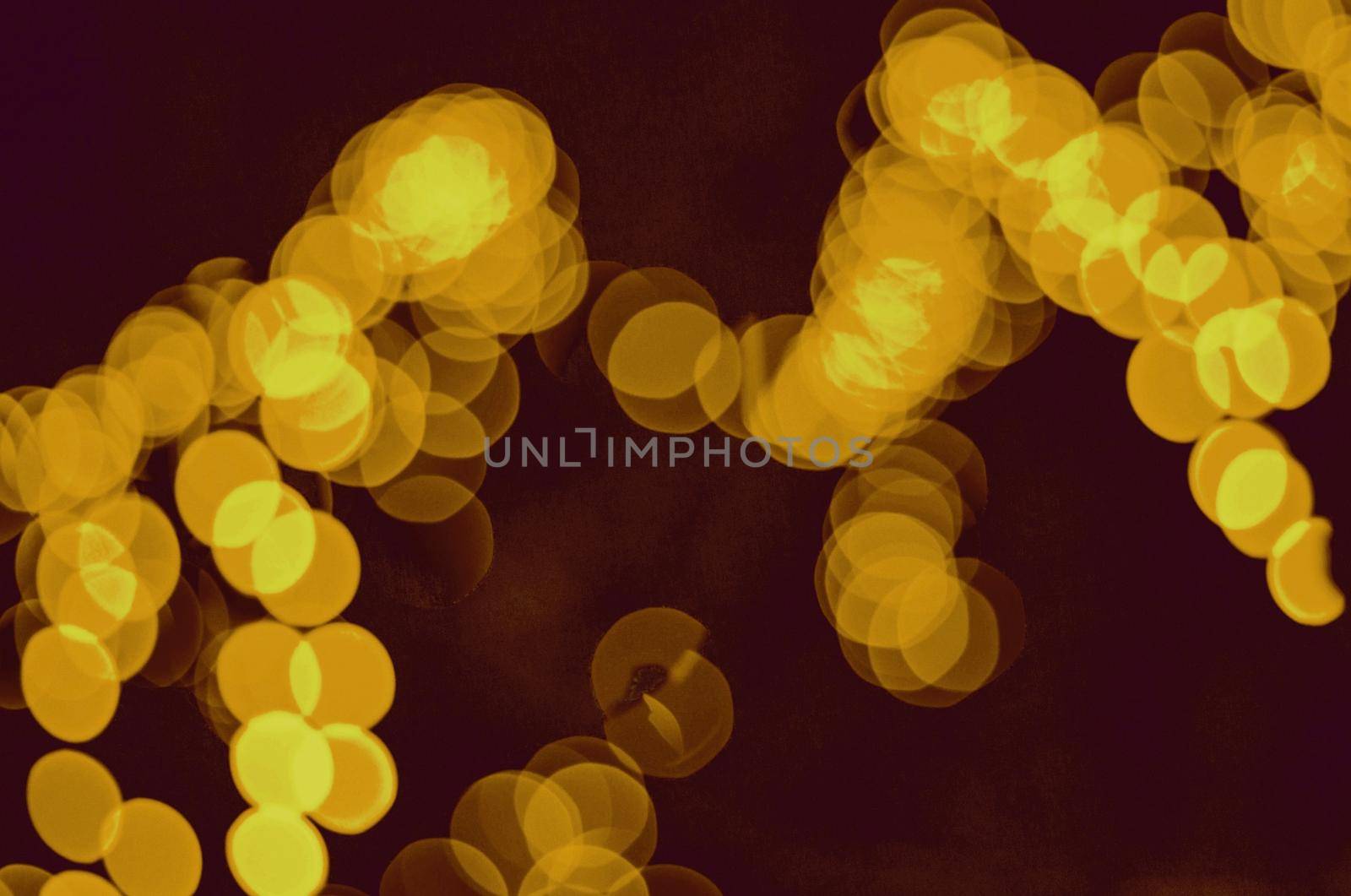 Blurred photo shows Illumination bulbs with yellow colours. by gelog67