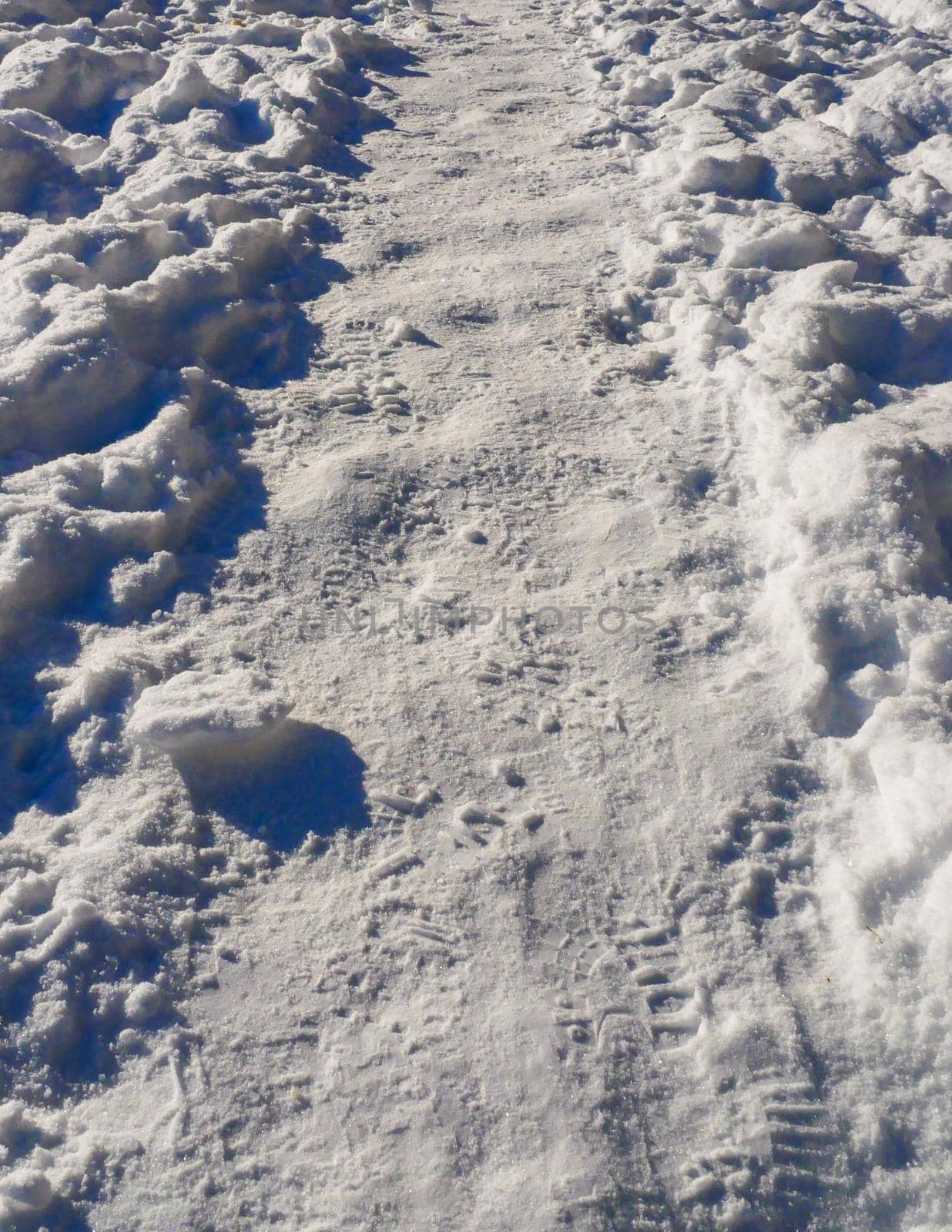 The path in the snow with human footprints. by gelog67