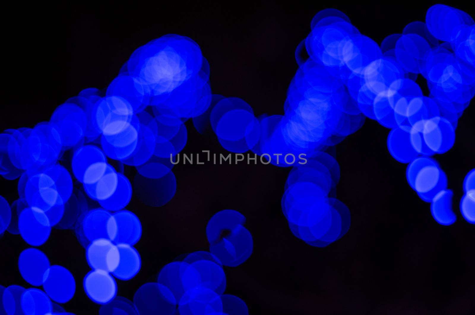 Christmas illumination from a blurry image of blue garlands.