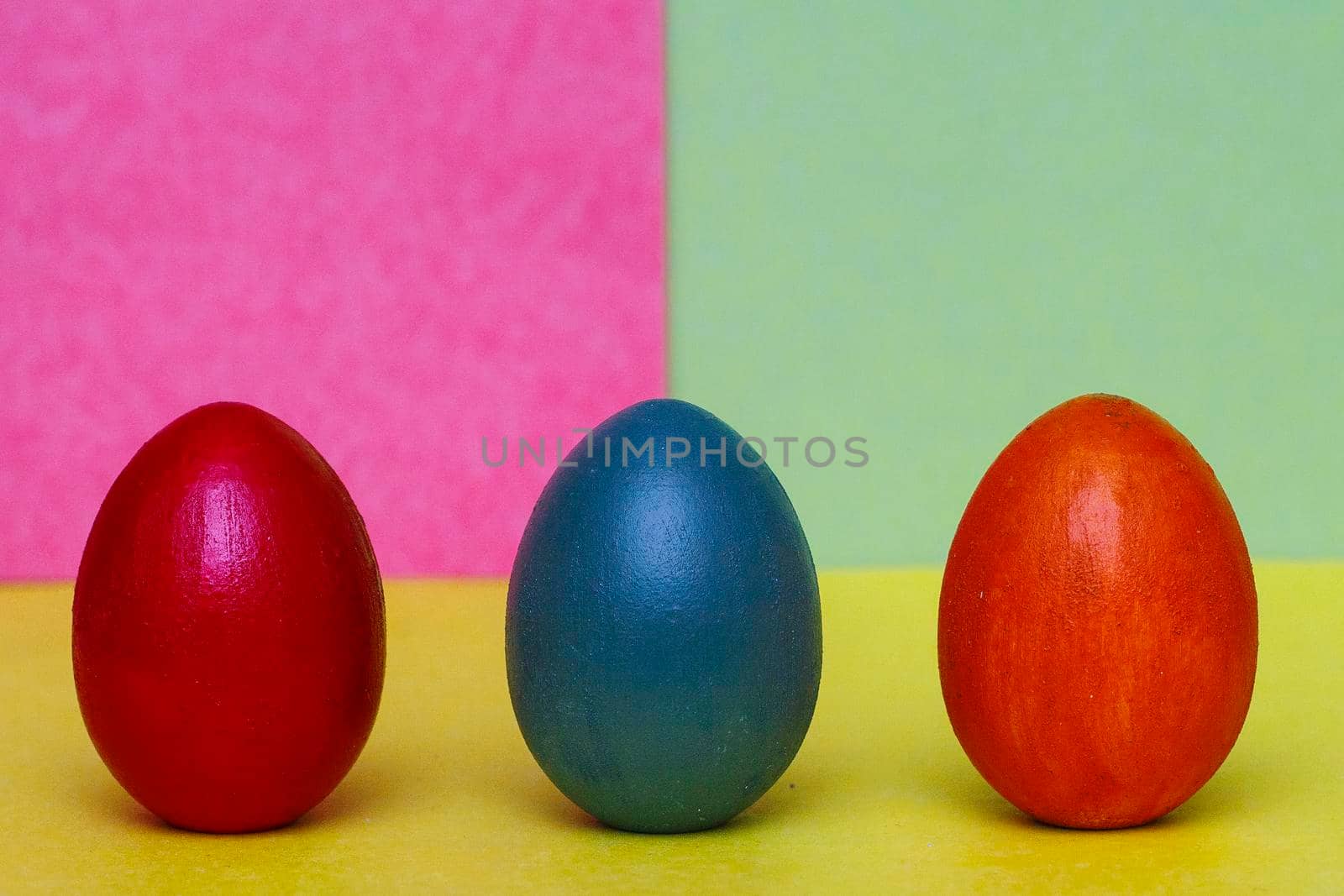 Three multi-colored decorative eggs on a three-colored background. by gelog67