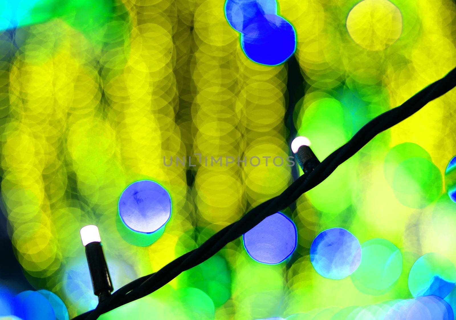 Blue bokeh close-up on a blurry backgroundof yellow garlands. by gelog67