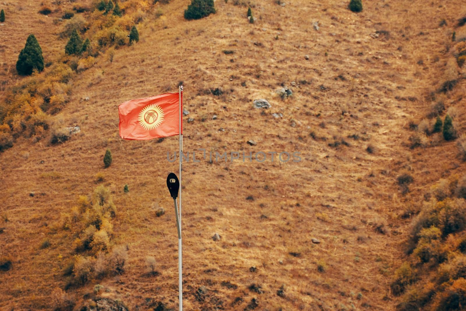 Flag in mountain. Leadership and success concept with blank red flag on mountain top.
