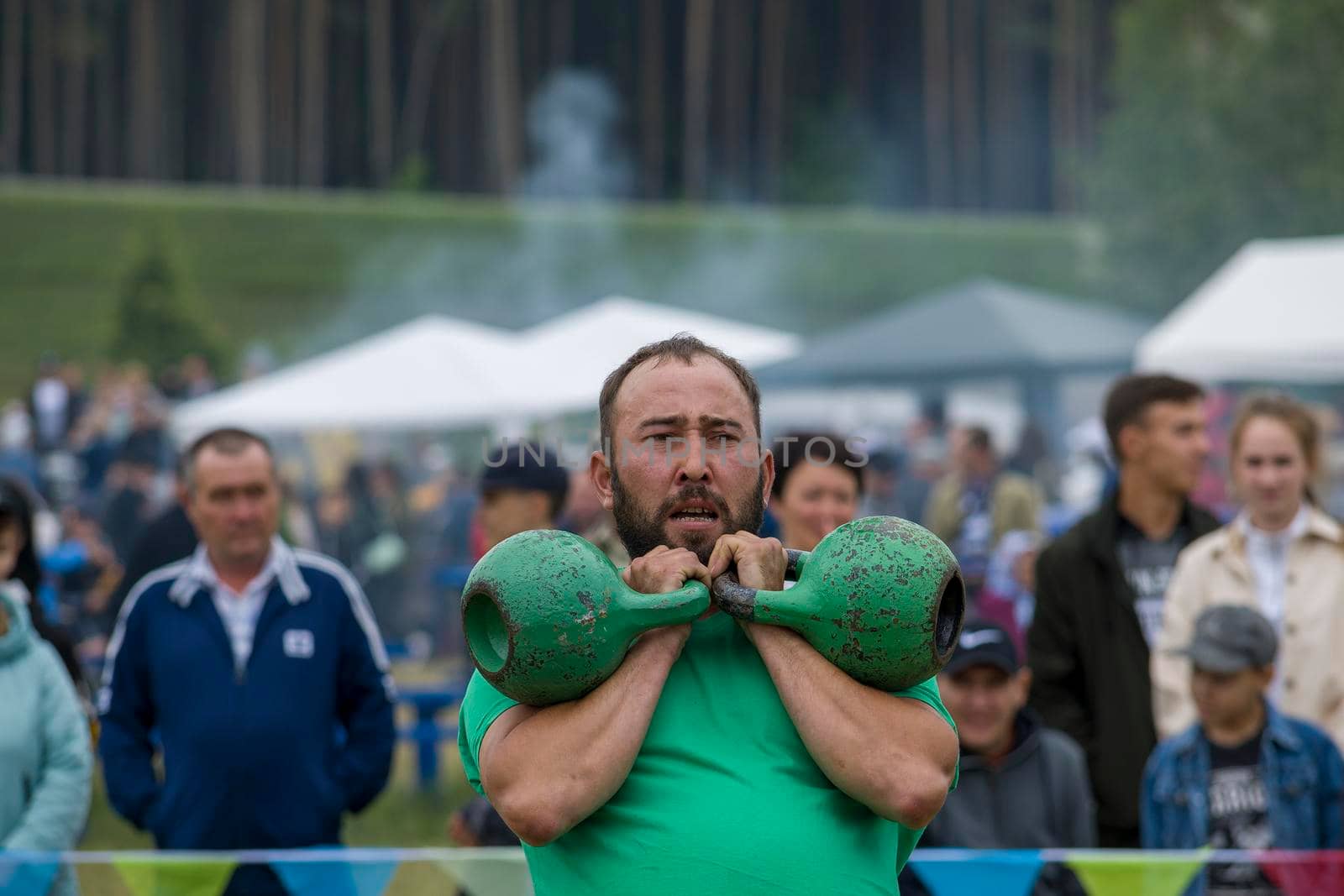 A man lifts a kettlebell sports equipment. Bashkortostan, Russia - 19 June, 2022. by Essffes