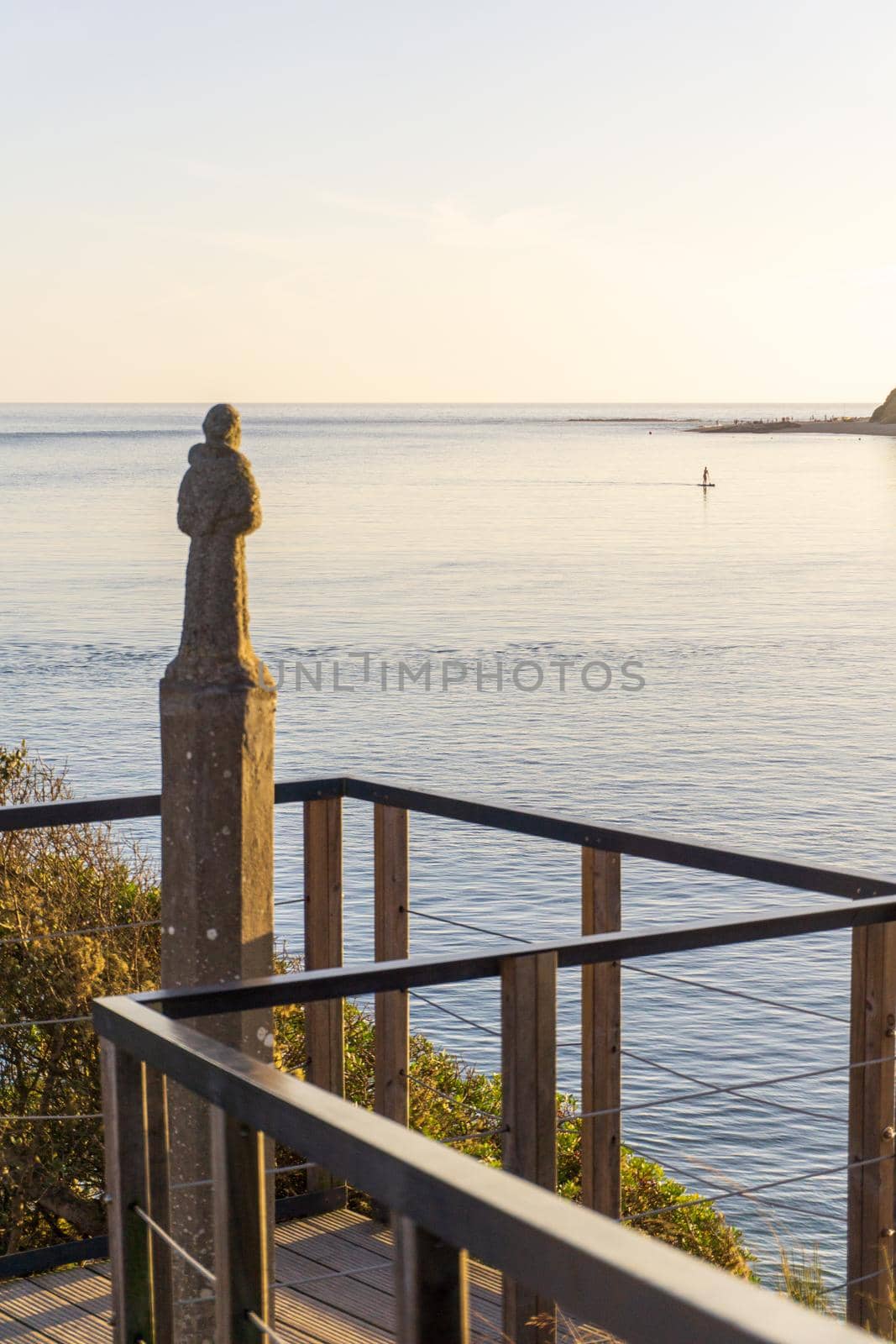 Religious statue looking into the sea at sunset. Portugal, Vila Nova de Milfontes