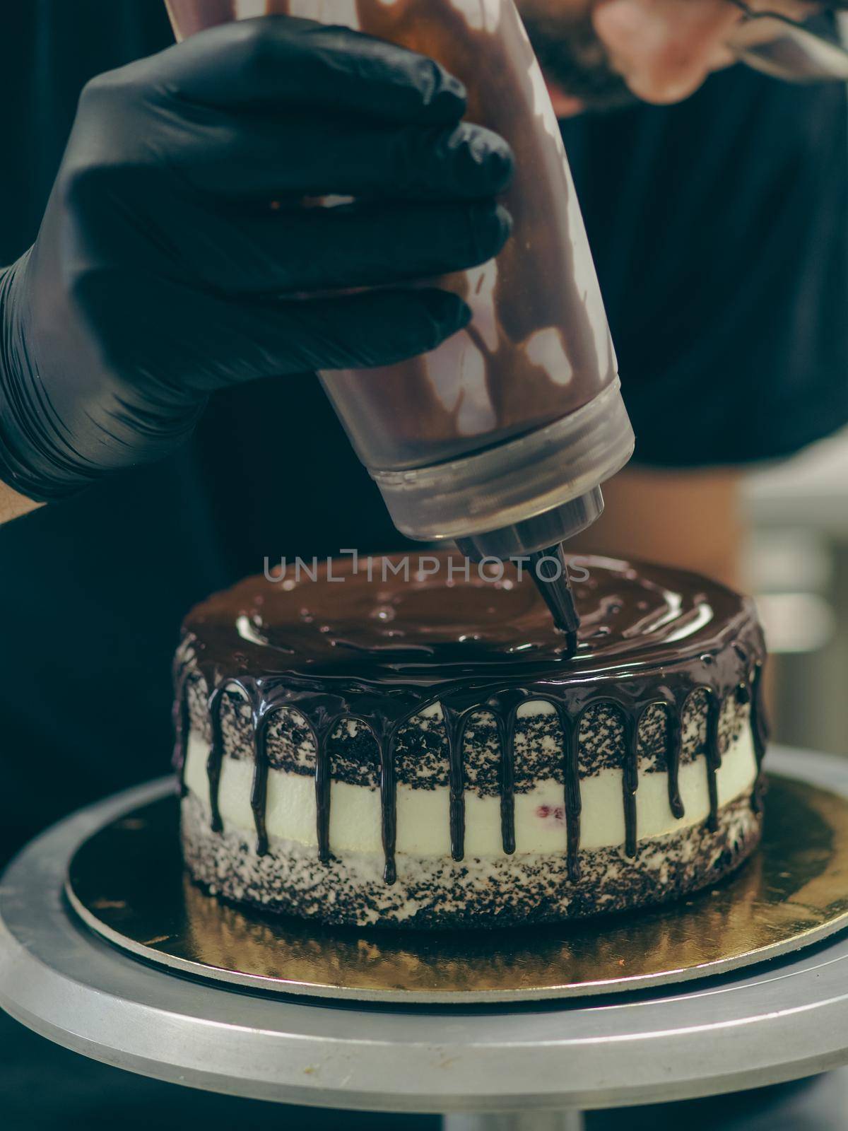 decorating a frosted cake with chocolate and nutella