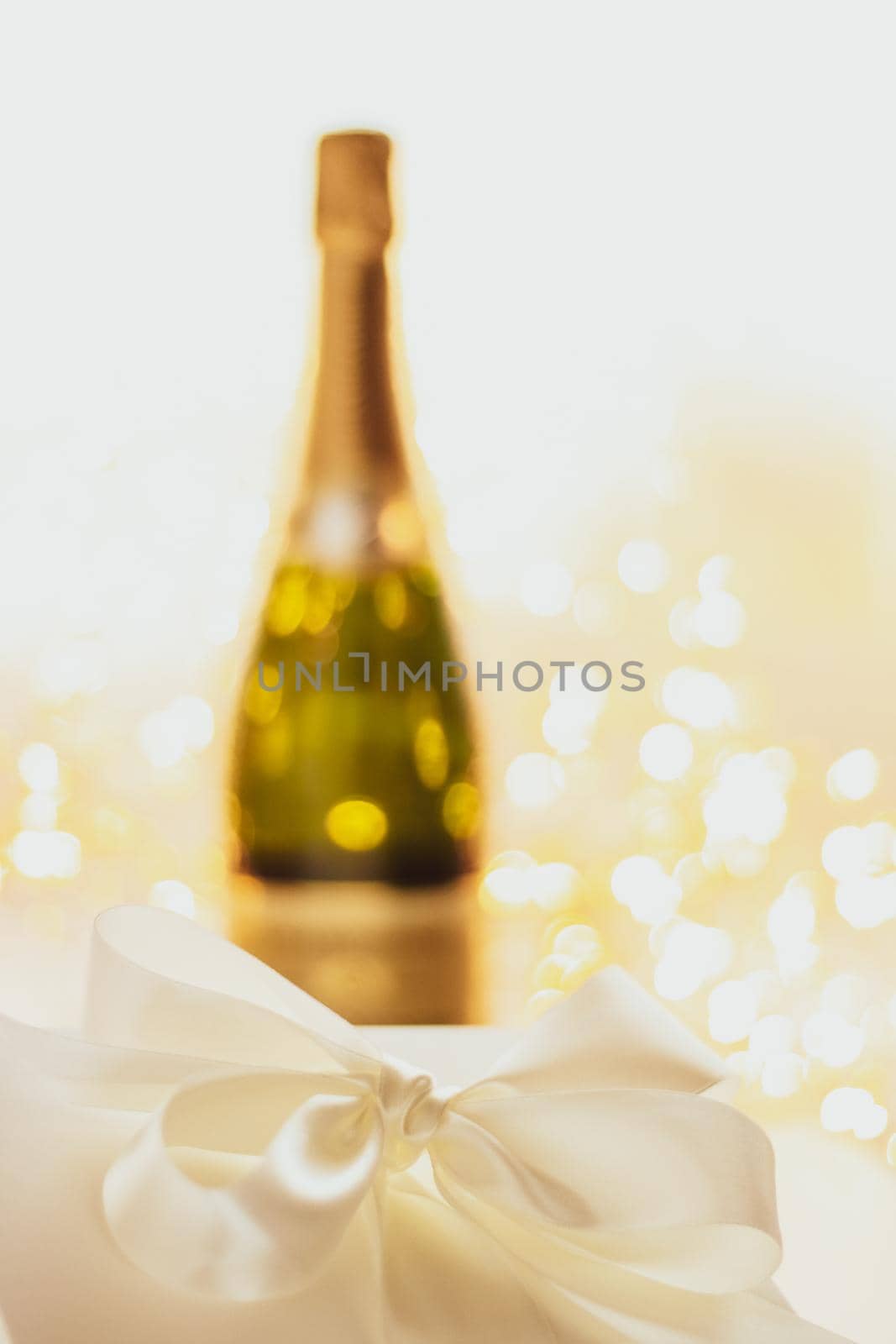 Romantic celebration, lifestyle and luxury present concept - The bottle of champagne and holiday gift box