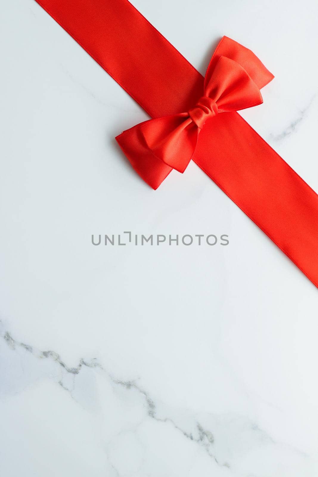 Holiday decor, feminine design and flatlay concept - Red silk ribbon on marble, top view