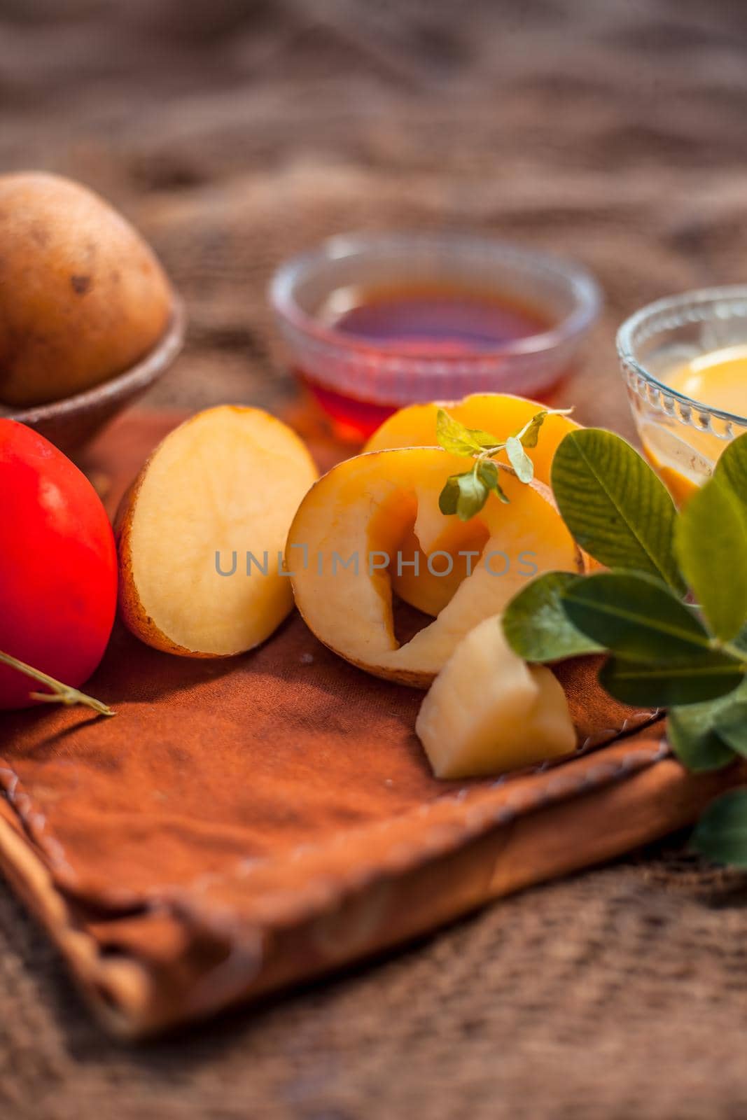 Potato juice's face pack for acne on jute bag's surface consisting of potato juice and tomato juice well mixed together with the help of honey.Vertical shot. by mirzamlk