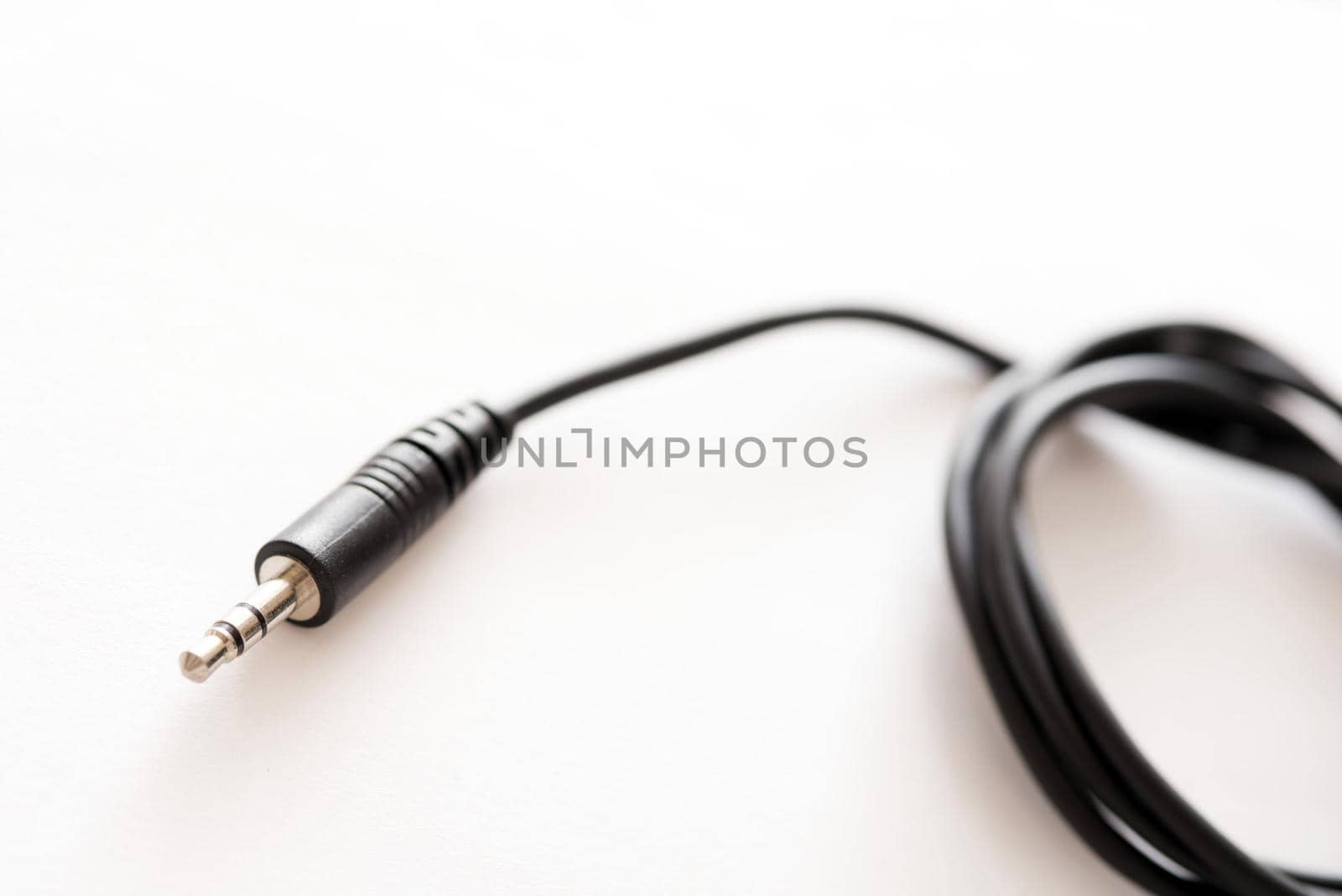 A black coloured audio lead with 3.5mm TRS jack plug on the end