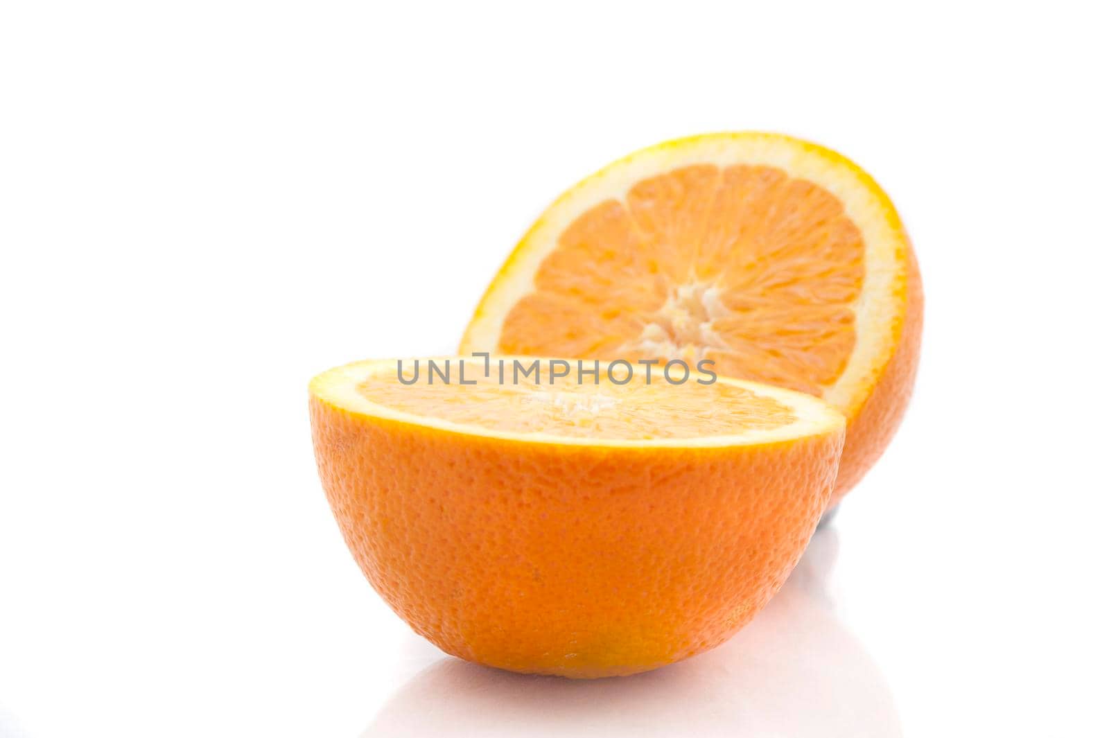 Ripe halved fresh orange showing the juicy pulp rich in vitamin c on a white background