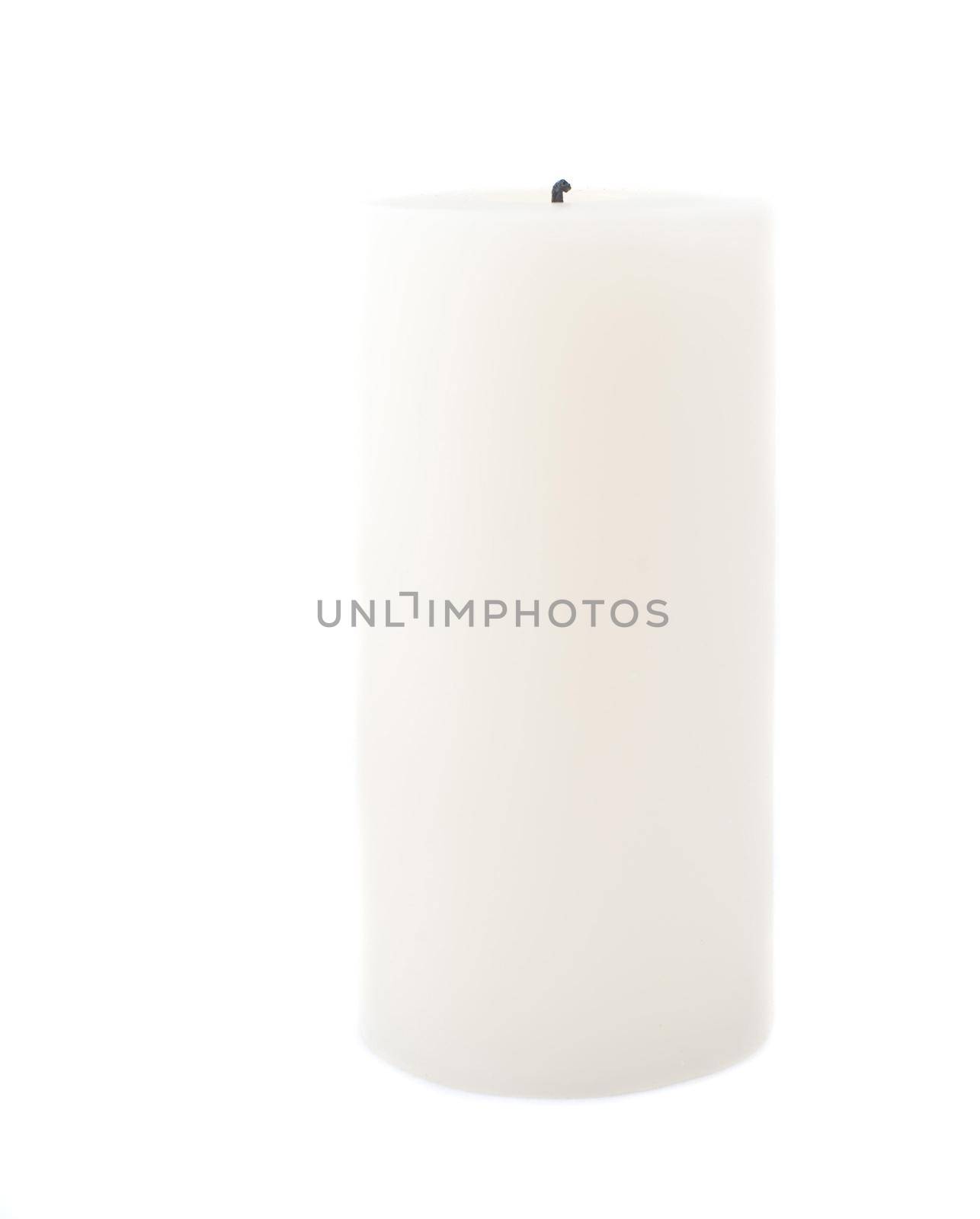 a large pillar candle isolated on a white backdrop