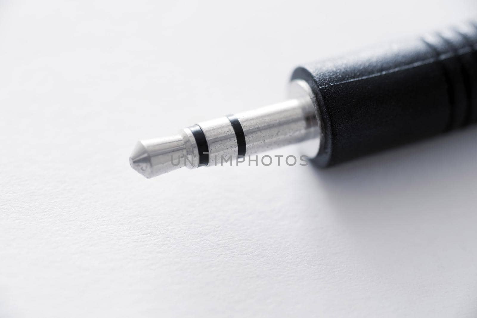 Close-up view of mini jack plug against white background