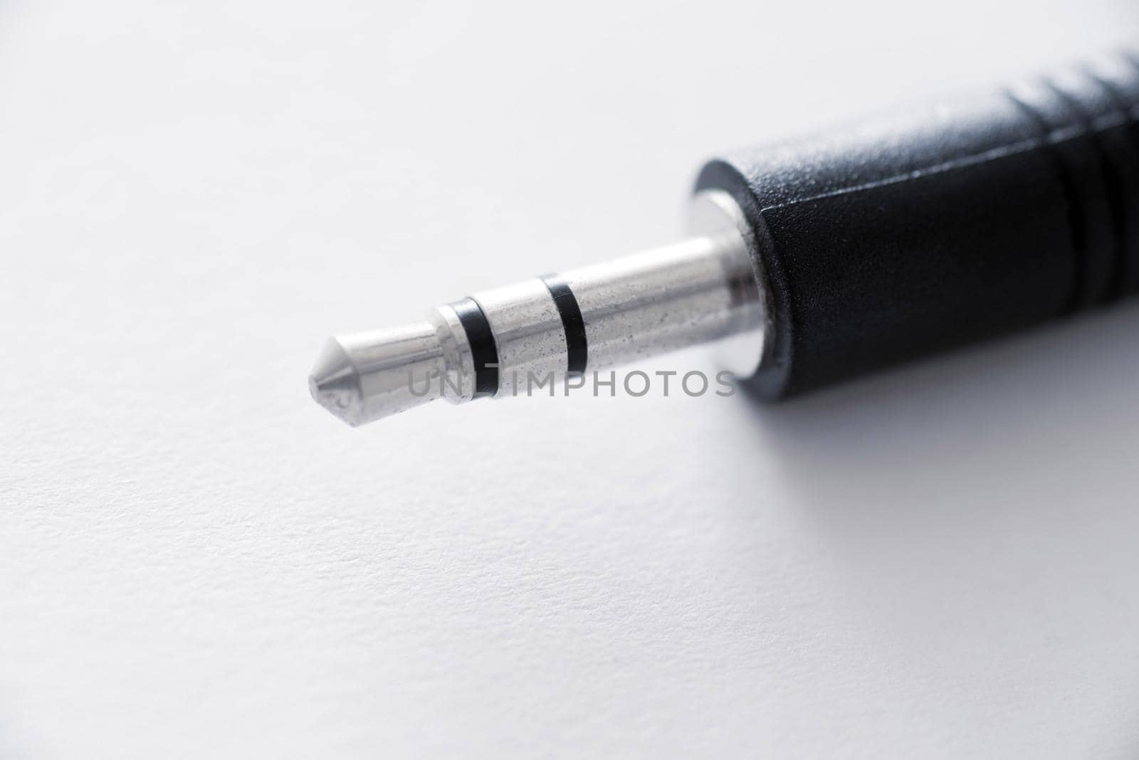 Close-up view of mini jack plug against white background