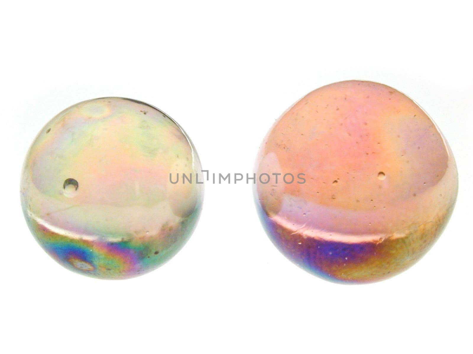 Close Up Still Life of Two Colorful Glass Marbles of Different Sizes Isolated on White Studio Background with Copy Space