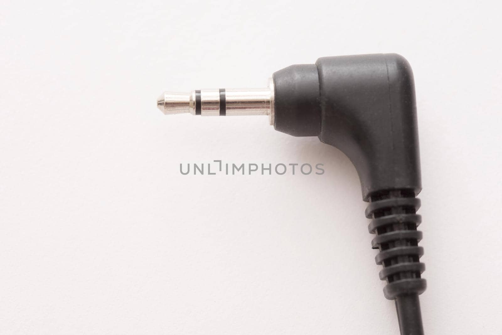 Simple black plastic stereo jack audio plug close-up on white background