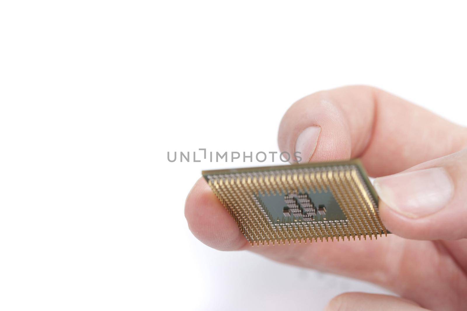 Man holding computer CPU with his fingers, close-up image on white background with copy space