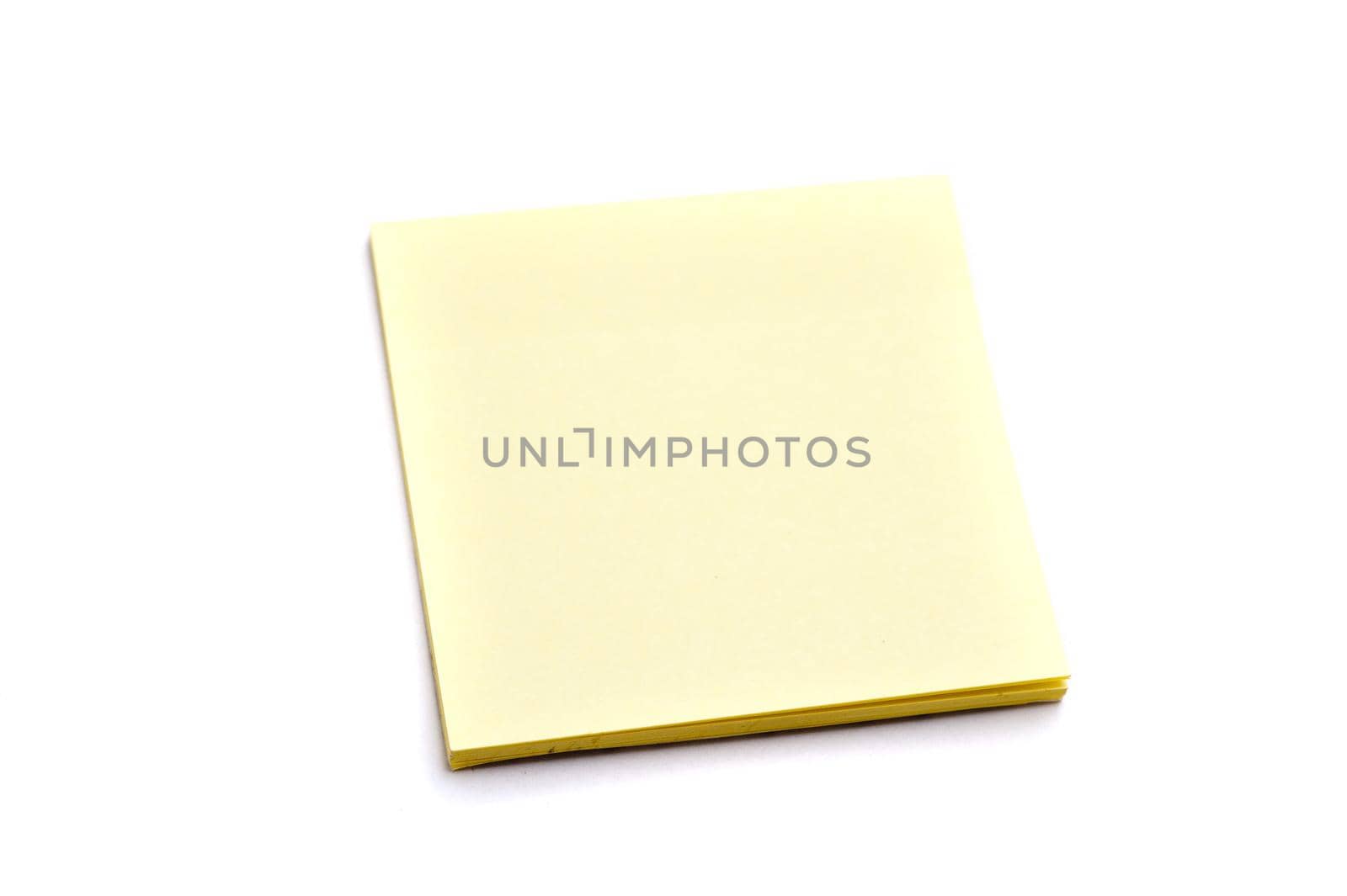 Block of yellow paper notes on white background