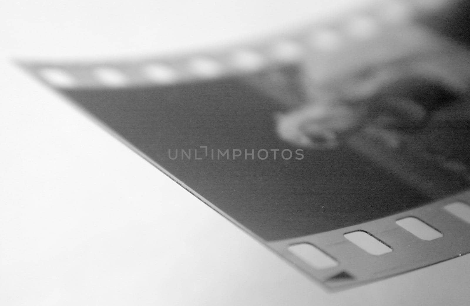 End of exposed 35mm negative film on studio background with copy space