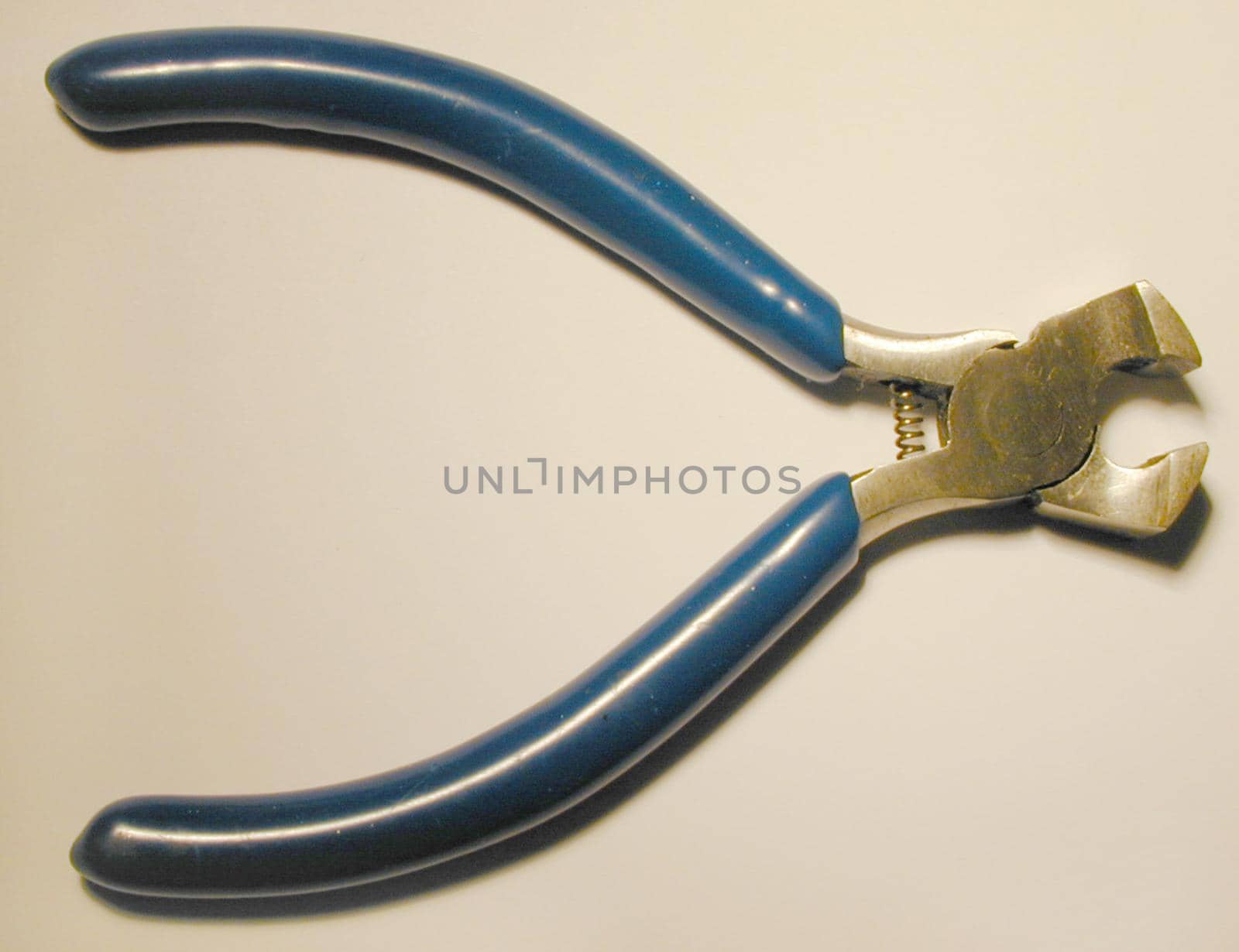Pair of steel cutters lying open on a white background viewed from above with copy space