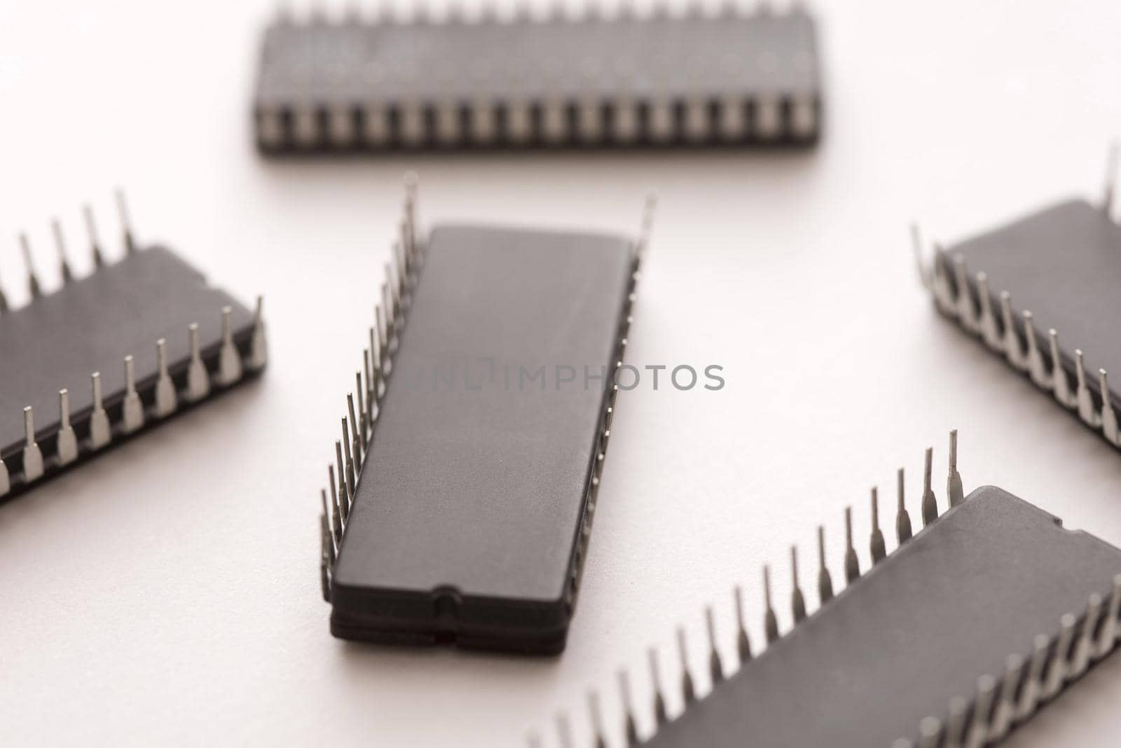 Black electronic chips upside down close-up on white surface background