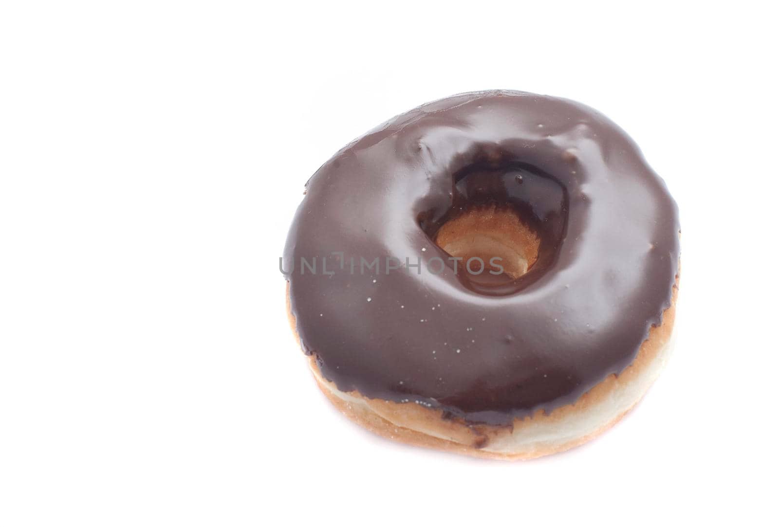 High angle view of a delicious chocolate frosted ring doughnut on a white background