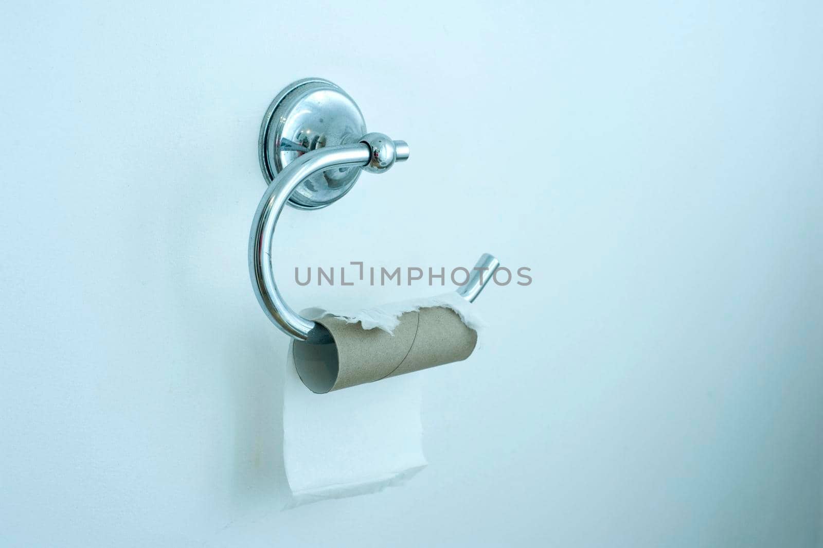 conceptual image: a toilet roll holder run out of paper