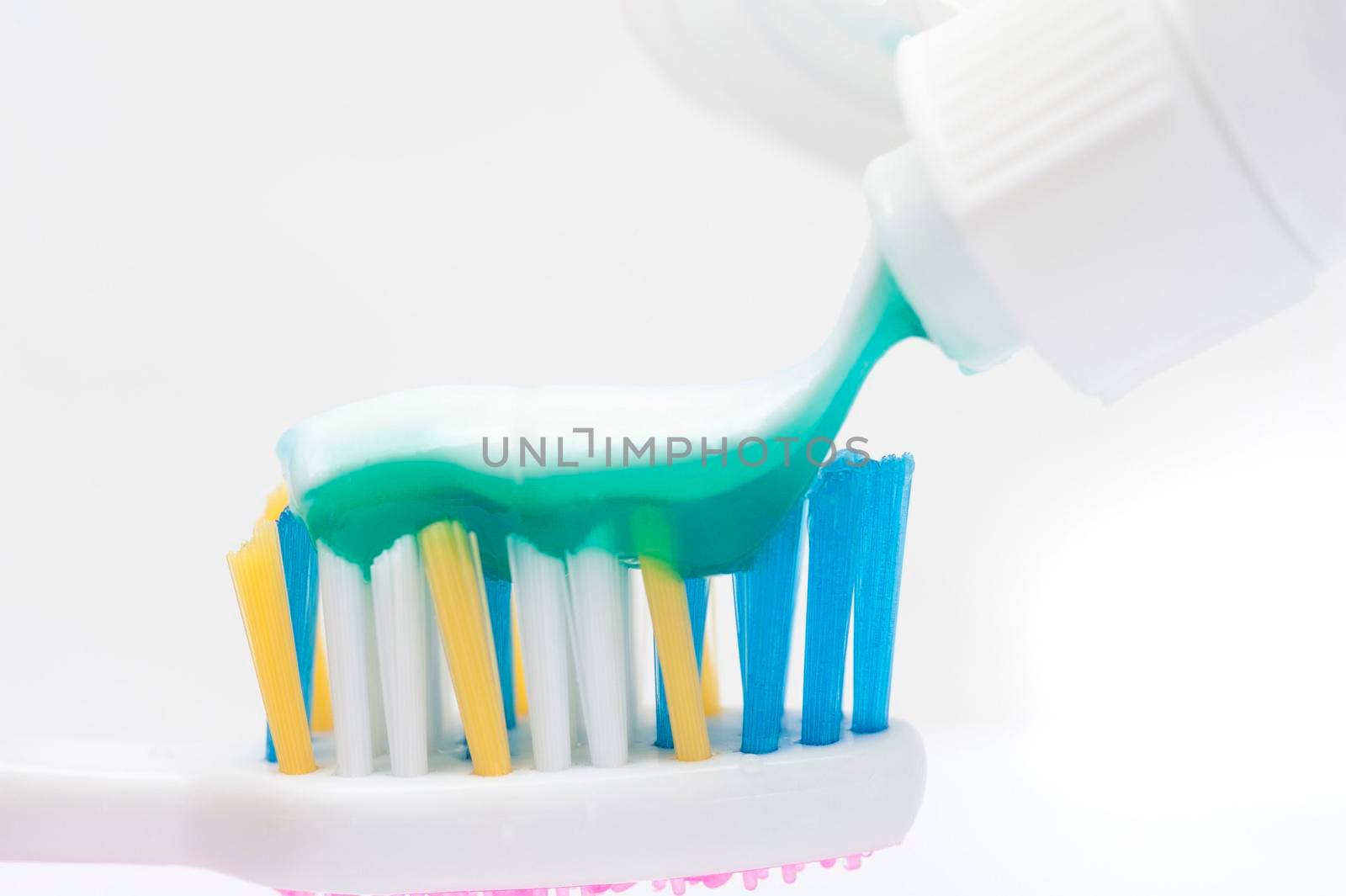 dispensing toothpaste onto a tooth brush