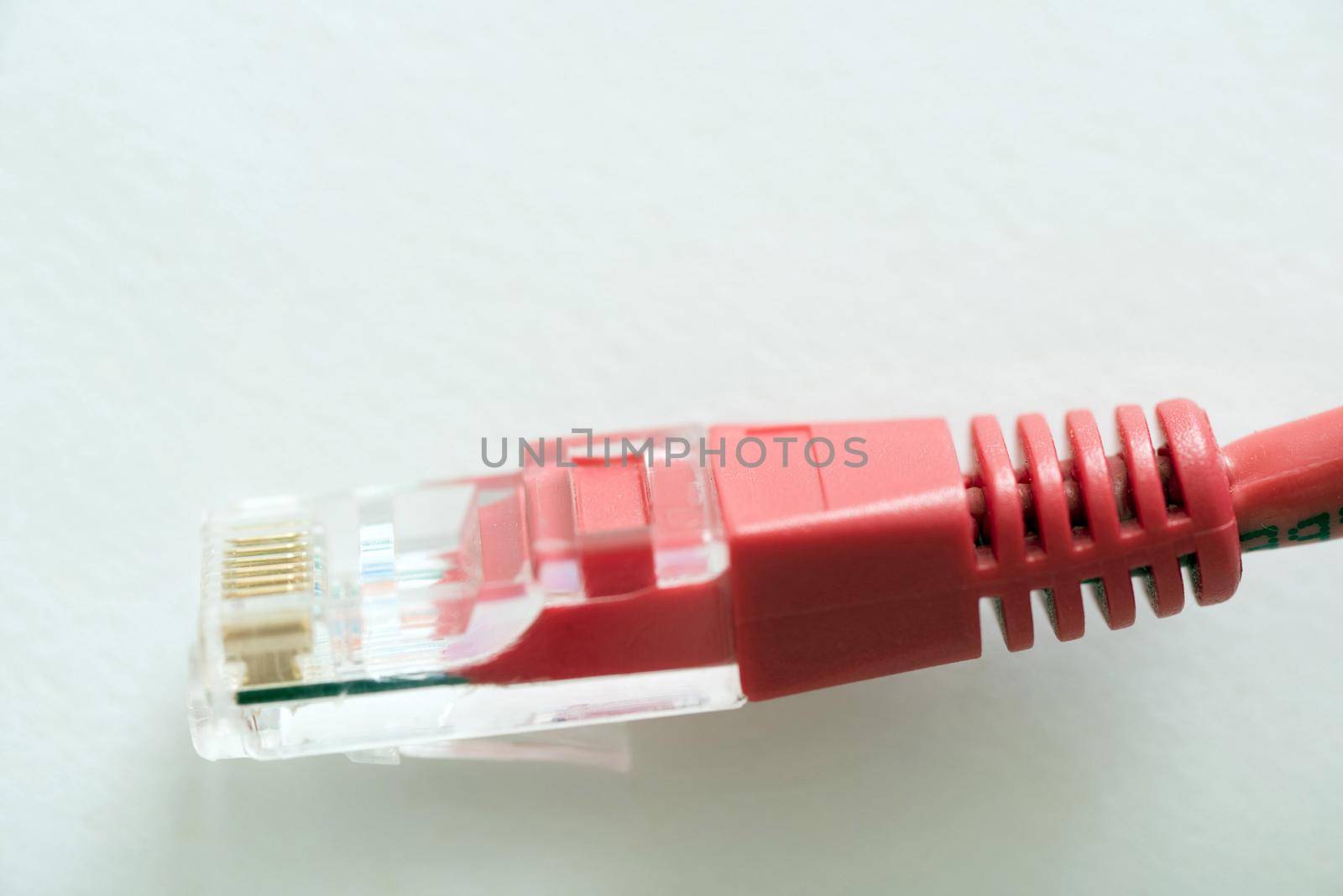 Close-up view of patchcord cable plug against white background