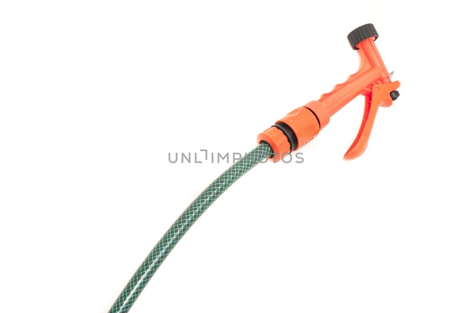 Plastic garden hose and orange nozzle for spraying and watering plants isolated on a white background