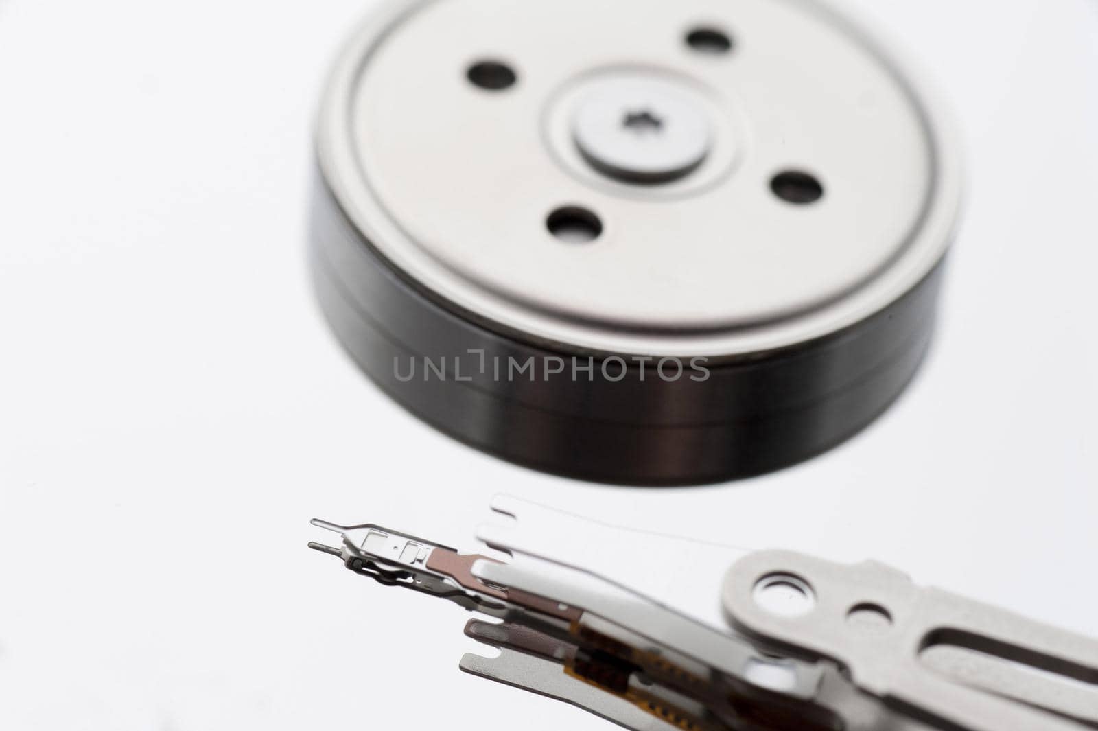 A close up of the internal components and parts of a computer hard disk isolated on a white background with copy space.